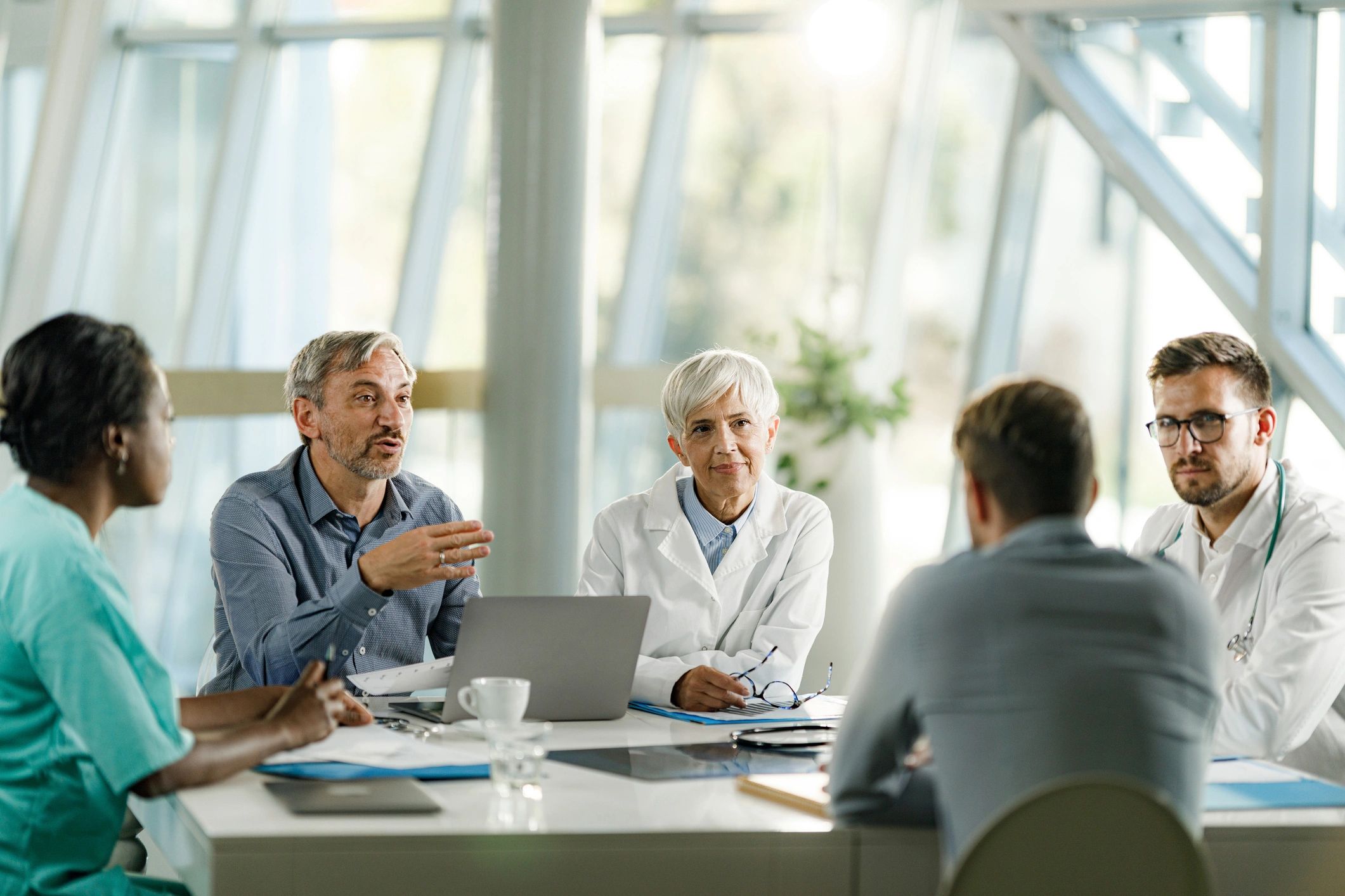 Healthcare and business professionals in a negotiation meeting
