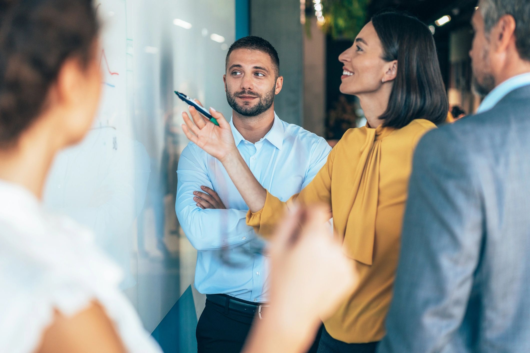 Team reviewing a workflow on a whiteboard