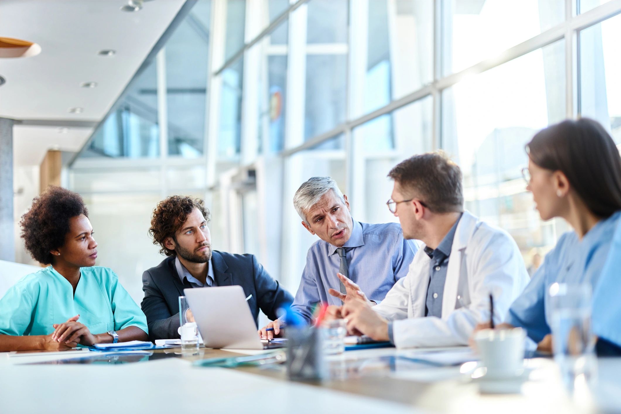 Clinical and business professionals collaborating in a hospital meeting