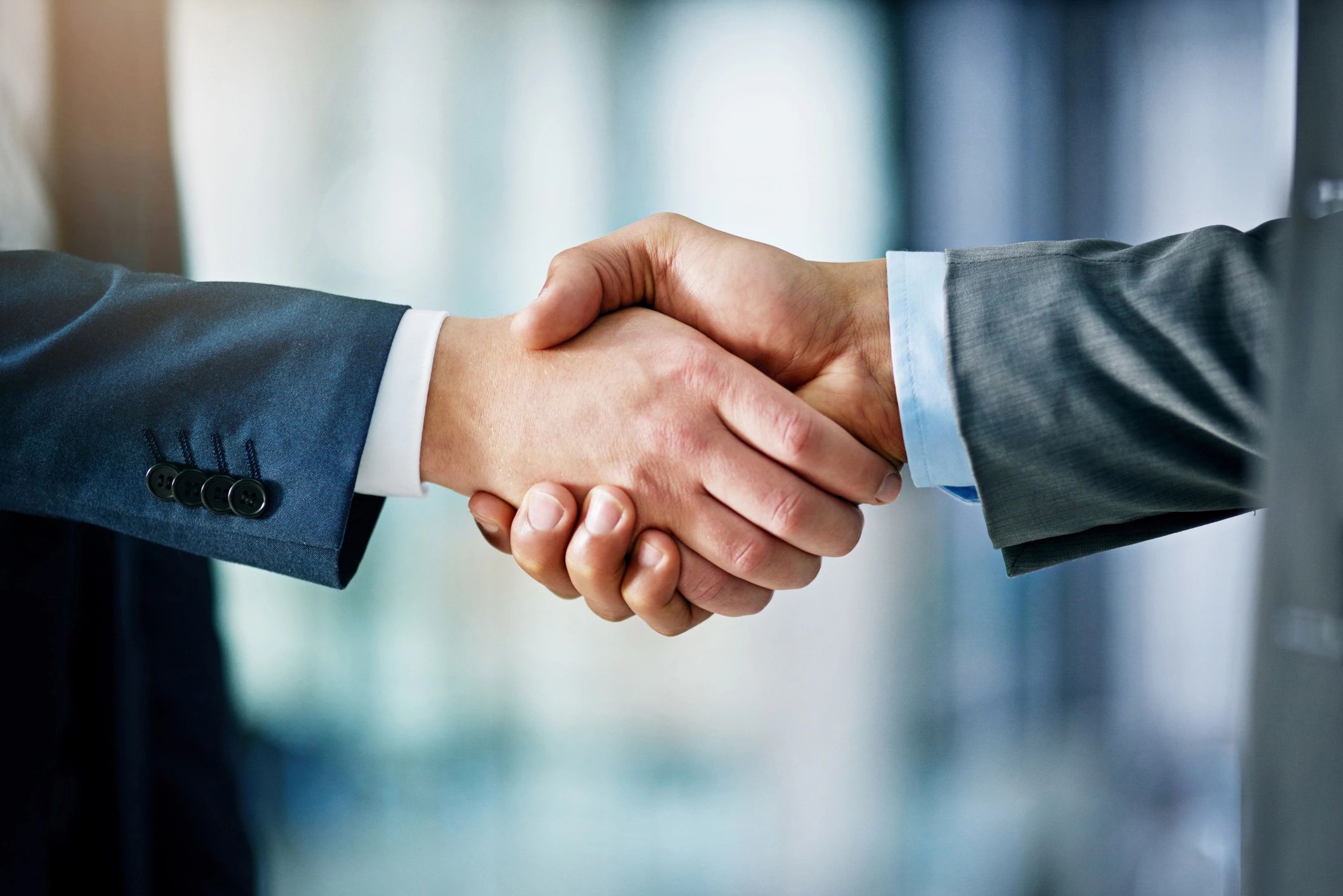 Handshake representing contract and budget negotiation support